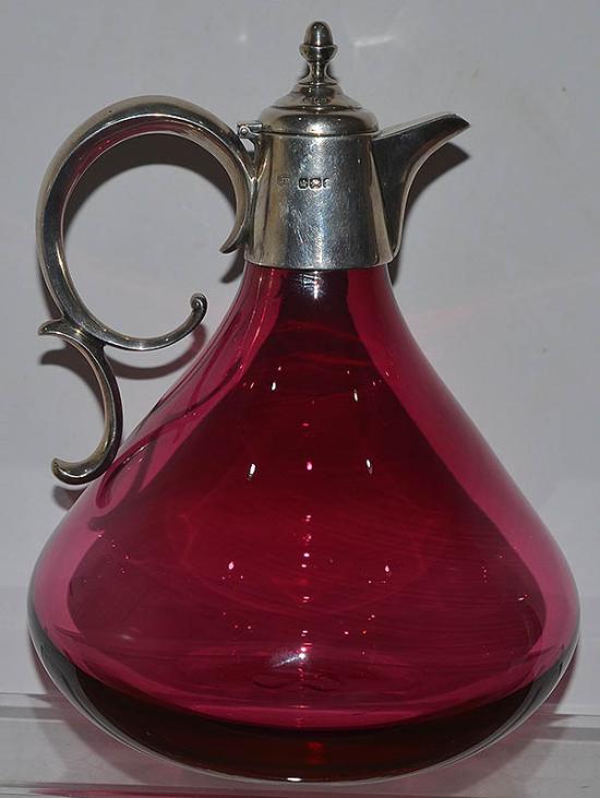 VICTORIAN CRANBERRY GLASS SILVER MOUNTED CLARET JUG.