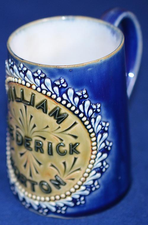 DOULTON CHRISTENING MUG WITH SILVER COIN.