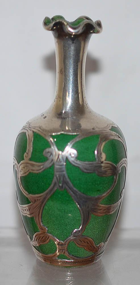 GREEN CERAMIC VASE WITH SILVER OVERLAY DECORATION.