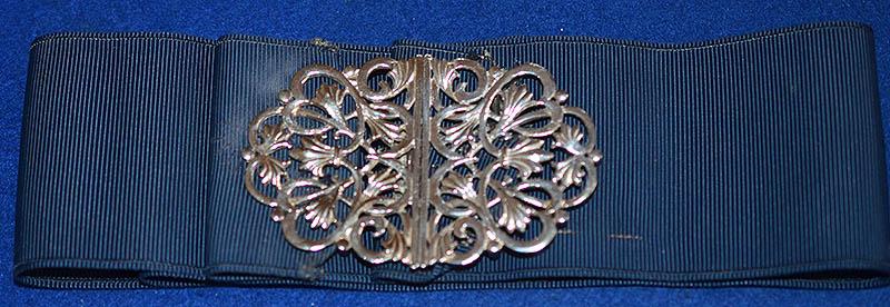 SILVER NURSES BUCKLE COMPLETE WITH ORIGINAL CLOTH BELT.